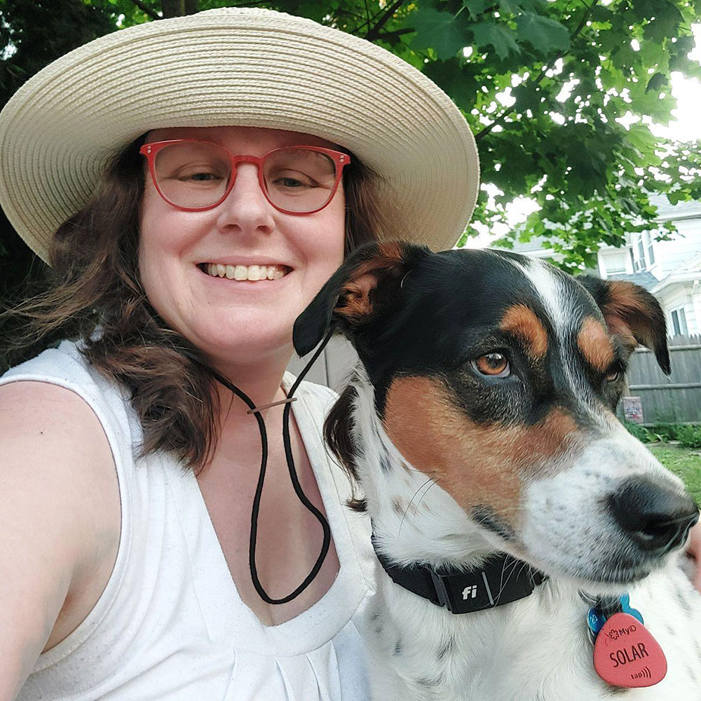 A photo of the artist, Jessica Grace Leahy and her service dog Solar.